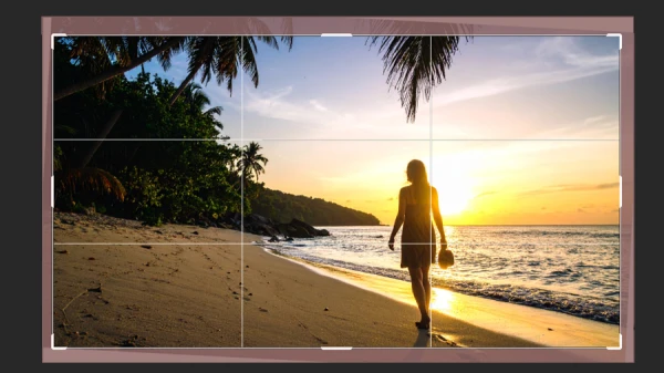 cropping grid over photo of woman walking on sunset beach in photoshop